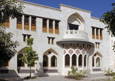 A façade of interspersed openings facing the courtyard.