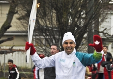 Azim Jamal carries the Olympic flame in Vancouver.