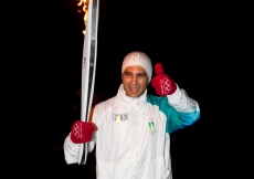 Sohail Shariff acknowledges the crowd as he carries the Olympic torch.