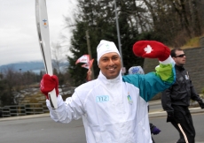 Pharid Jaffer carries the Olympic flame in Abbotsford, British Columbia.