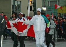 Ismaili Council for Canada Vice-President Malik Talib carries the Olympic flame in Vancouver.