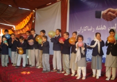 Junior volunteers compete in a balloon-blowing contest &amp;mdash; part of the fun and games of Volunteer Week in Afghanistan.