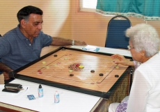 Seniors enjoying a game of carrom at the Far East Jamati Sports Day held in Penang.