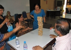 At the Penang Sports Day, a Jamati member contemplates how to make her next move without toppling the precarious Jenga tower.