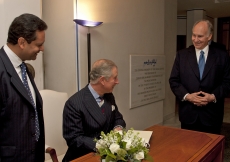 With Mawlana Hazar Imam and President Amin Mawji looking on, Prince Charles signs the guest book before departing the Ismaili Centre, London.