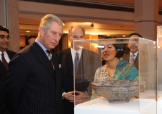 Mawlana Hazar Imam and Prince Charles examine an artefact on display at the Ismaili Centre, London.