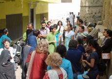 A guide trained by AKTC leads visitors on a tour of the Nizamuddin Basti.