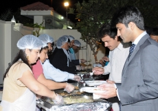 Volunteers serving dinner to the Jamat qho had gathered in Doha.