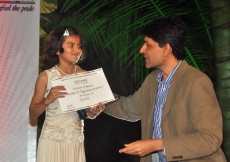 Ten-year-old Anam Tyrewala receives her award from Chief Guest Geet Sethi at the Youth Awards for Excellence, 2010 in India.