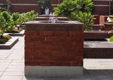 Water sprinkles from a courtyard fountain at the Ismaili Jamatkhana Lahore.