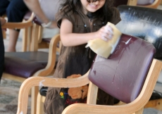 A young child helps prepare for Mawlana Hazar Imam&amp;rsquo;s visit to Tanzania by cleaning a chair.