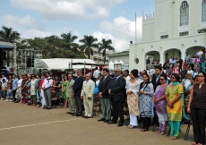 Leaders and members of the Jamat line up outside of Kampala Jamatkhana to witness the flag raising ceremony.