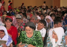 Members of the Jamat receiving Eid gifts, including Ismaili Centre, Dushanbe commemorative pins.