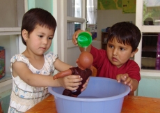 Children learn to care for their environment and for others through games such as this one, where they are taught important lessons in health, hygiene, and responsibility for others.