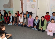 Tahmina Shayan with other teachers and students celebrate Afghanistan’s culture through song, poetry and dance, in a room they worked together to decorate.