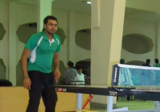 A table tennis player readies himself for the start of a game.