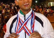 An accomplished athlete shows off his medals.