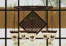 The square-in-square motif is visible in this etched glass chandelier hanging in the Ismaili Jamatkhana and Centre, Kinshasa.