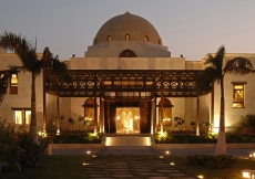 The entrance of the Ismaili Centre, Dubai is adorned by fountains, trees and a five-arched teak and meranti portico.