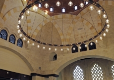 The congregational hall of the Ismaili Centre, Dubai features the building's largest dome. Its octagonal shape is supported by meticulously engineered heavy corbels, which dominate the space. The ambience is set by the enormous brass chandelier from Egypt