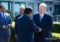 Mawlana Hazar Imam bids farewell to Lord Ahmad of Wimbledon, as President Liakat Hasham and Vice-President Farhad Mawani look on.