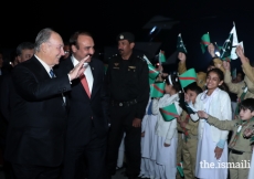 Mawlana Hazar Imam waving happily at the jubilant shaheen scouts and junior guides upon his arrival.