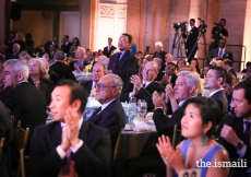 Mawlana Hazar Imam applauds after the musical performance by Wu Tong.