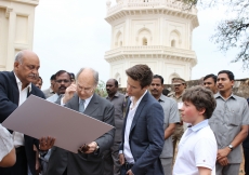 The landscape architect explains to Mawlana Hazar Imam the proposed design for the first phase of work at the Qutb Shahi Heritage Park, as Prince Aly Muhammad and Iliyan listen attentively. AKDN / Lipi Bharadwaj