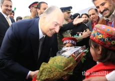 Mawlana Hazar Imam is presented with a bouquet of flowers upon his arrival at the Gilgit airport 