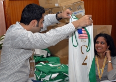 Volunteers prepare uniforms for the athletes during the Golden Jubilee Games. JG