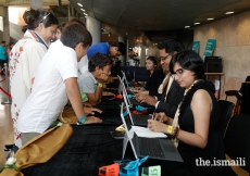 Registration volunteers help Jamati members check- in for the Diamond Jubilee Celebration Lisboa 2018.