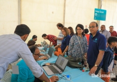 Help desk volunteers are ready to assist new arrivals to the Diamond Jubilee Celebration - Lisboa 2018.