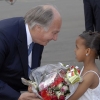 Mawlana Hazar Imam being presented with a bouquet of flowers by seven-year-old Ramla Saleh upon arrival in Nairobi.  