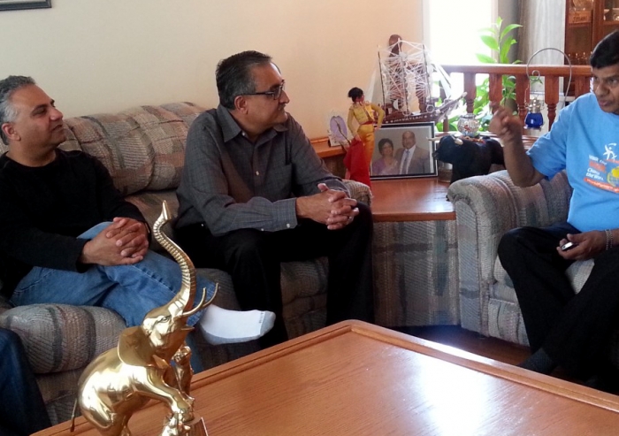 Ismaili Council for Canada President Malik Talib, Honorary Secretary Arif Amlani
and President Mohamud Zaver of the Ismaili Council for the Praries visit with a host family and their guest, who was evacuated from a flooded Calgary neighbourhood.