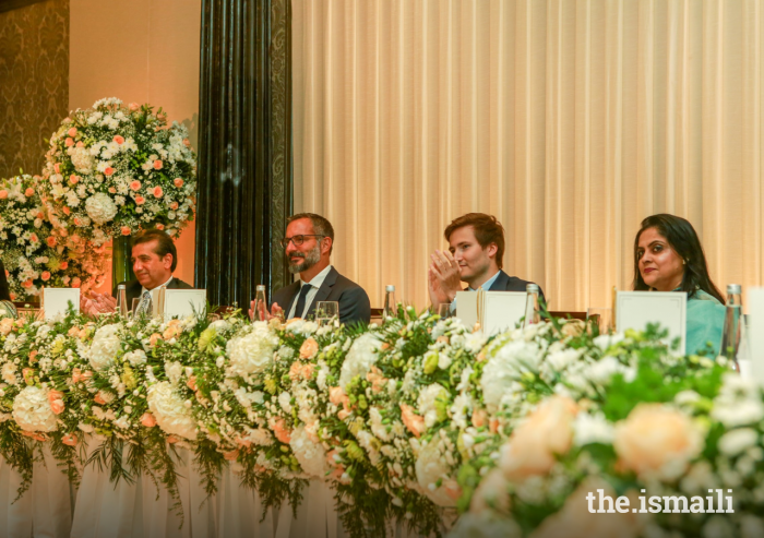 Prince Rahim and Prince Aly Muhammad applaud a performance by members of the Jamat at an Institutional Dinner in Mumbai, India.