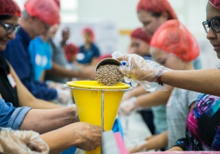 Members of the Ismaili Muslim community and other volunteers, in partnership with Feeding Children Everywhere, pack 100,000 healthy meals Sunday at Ismaili Jamatkhana and Center in Carrollton. The meals will be delivered to victims of Hurricane Harvey.