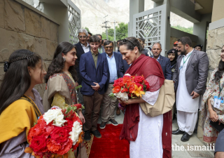 Princess Zahra is greeted with a bouquet of flowers upon arriving to the new Aga Khan Hostel in Sherqilla.