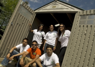 Edmonton youth pose outside one of the sheds they built in partnership with Habitat for Humanity. 