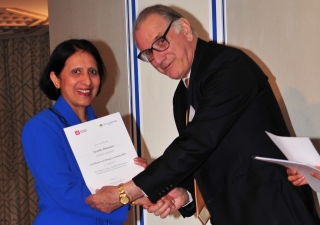 Keith Mackrell hands a certificate to a
delighted graduate.