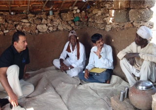 Munir Samji speaks with to two Siddhi farmers. With advice and assistance from AKRSP, many of the farmers have improved in their income from the land — in some cases doubling it.