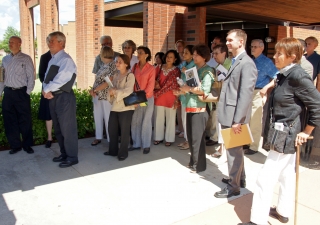 Following a presentation at the Houston Principle Ismaili Jamatkhana and Center, audience members listen to a tour guide explain Islamic and Western architectural concepts represented by the Center,