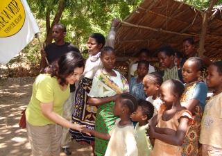 Shahinoor M. Visram, Managing Trustee of the Sun n Sand Trust, greets children in the village of Kikambala, Kenya where the Visram family has made important contributions to combating human trafficking and improving quality of life in the local community.