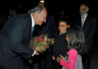 Mawlana Hazar Imam is greeted upon arrival in Nairobi, Kenya, by Mussa Abdul Dossa and Azmira Shamsudin, as Aitmadi Zul Abdul, President of the Ismaili Council for Kenya looks on.

