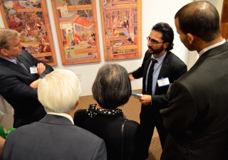 A guide explains the exhibition to guests at the Enlightened Encounters outreach event held at Chicago Headquarters Jamatkhana in Glenview, IL.