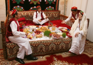 A family illustrates a traditional Tajik Navroz meal according to the “haft-shin” and “haft-sin” traditions.  