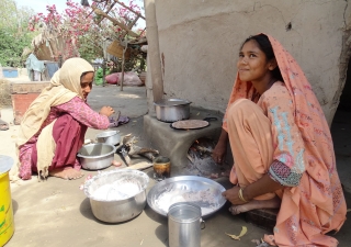 A housewife and her daughter in Ishaq Holani village in Sind using an energy efficient stove