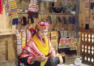 FMFB-P has provided micro loans in the mountainous valley of Chitral called Kalash where this women is making a traditional Kalashi dress in her small shop. Taking a micro loan allows women like this one to send her children to school.