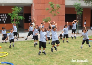 At the Aga Khan Academy in Hyderabad, India, teachers and students enjoy a fun moment of sport together on the campus lawn.