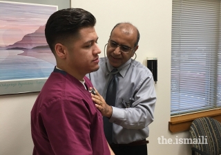 Dr Amyn Alidina examines a patient.