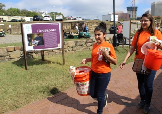 I-CERV volunteers carry orange buckets collecting funds in support of the Richmond Folk Festival.